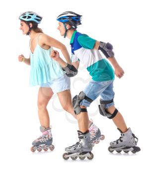 Teenagers on roller skates against white background�