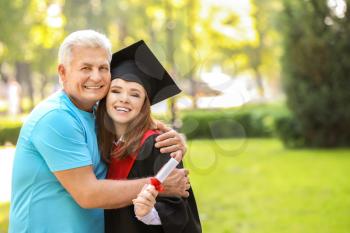 Happy young woman with her father on graduation day�