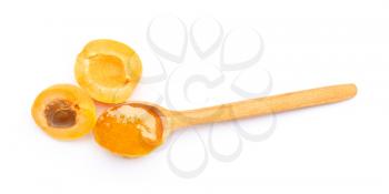Spoon with tasty apricot jam on white background�