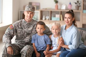 Happy military man with his family at home�