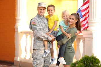 Happy military man with his family outdoors�