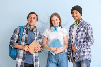 Portrait of young students on color background�