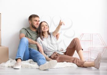 Young couple planning design of their new house�