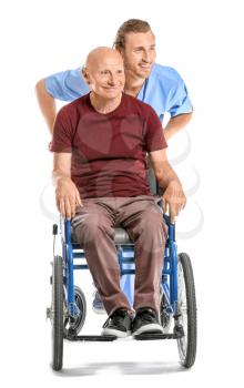 Handicapped elderly man with caregiver on white background�