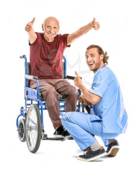 Handicapped elderly man with caregiver showing thumb-up on white background�