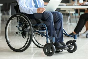 Handicapped young man working in office�