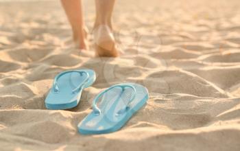 Flip-flops on sand beach at resort�