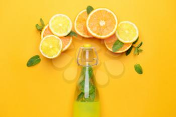 Bottle of fresh infused water with fruits on color background�
