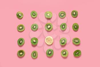 Many slices of kiwi and one lemon on color background. Concept of uniqueness�