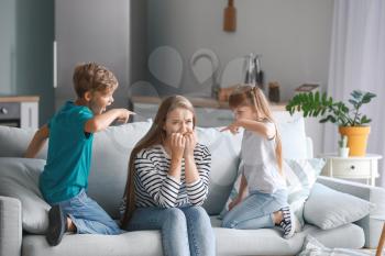 Angry children scolding their mother at home�