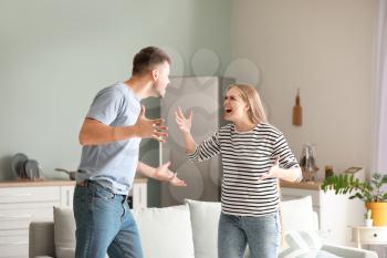 Angry couple having arguments at home�