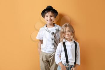 Stylish little children on color background�