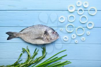 Composition with raw dorado fish on wooden background�