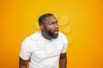 Shocked African-American man on color background�