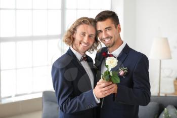 Happy gay couple on their wedding day at home�