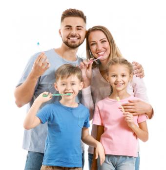 Portrait of family with toothbrushes on white background�