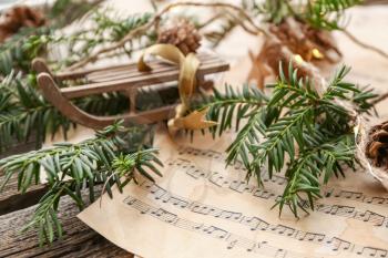 Christmas composition with music notes on wooden table�