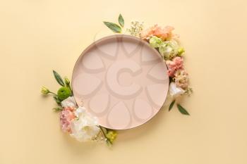 Beautiful composition with flowers and empty plate on color background�