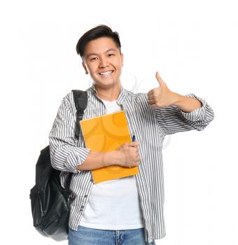 Portrait of Asian student showing thumb-up gesture on white background�