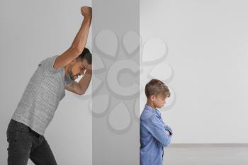 Father talking to his little son through the wall. Concept of misunderstanding between parent and child�