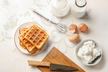 Composition with tasty waffles and ingredients on table�