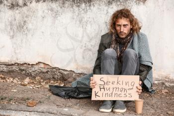 Portrait of poor homeless man outdoors�