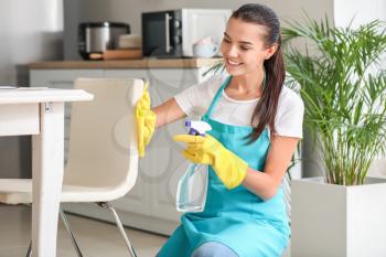 Portrait of female janitor cleaning kitchen�