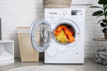 Interior of home laundry room with modern washing machine�