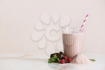 Glass of protein shake on light table�