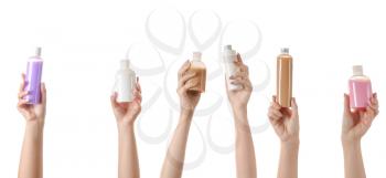 Female hands with different cosmetic products in bottles on white background�