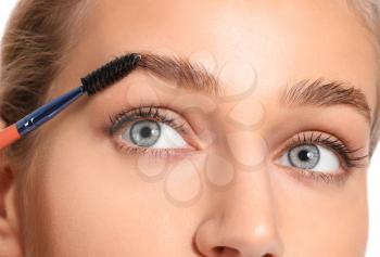 Young woman undergoing eyebrow correction procedure, closeup�