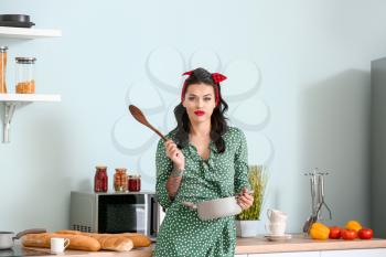 Portrait of beautiful pin-up woman cooking in kitchen�