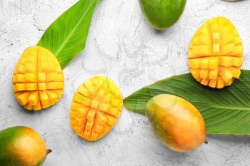 Sweet ripe mangoes on light background�