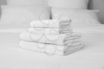 Clean soft towels on bed�