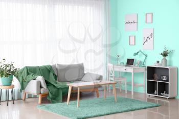 Stylish interior of living room in turquoise color�