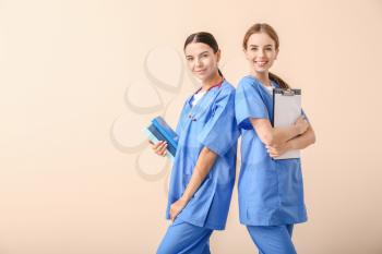 Female medical students on light background�