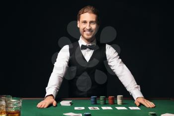 Young male banker at table in casino�