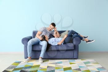 Young couple resting on sofa at home�