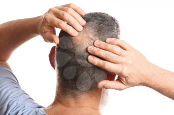 Senior man with hair loss problem on white background�