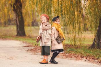 Cute little girls in autumn clothes outdoors�