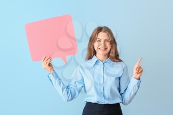 Young businesswoman with blank speech bubble on color background�