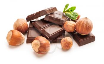 Tasty chocolate with hazelnuts on white background�