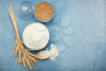 Flour with wheat grains on color background�