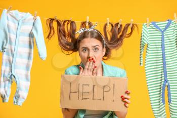 Funny housewife with laundry on color background�