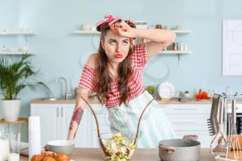 Funny tired housewife in kitchen�