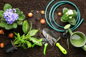 Set of gardening supplies on soil�