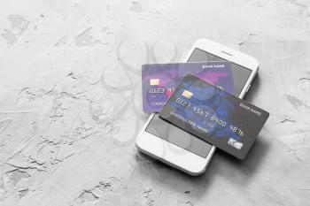 Credit cards with mobile phone on grunge background. Concept of online banking�