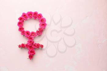 Symbol of woman made of rose flowers on color background. Concept of feminism�