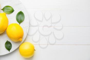 Fresh ripe lemons on white table�
