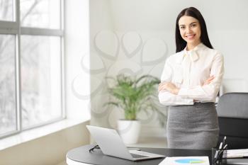 Portrait of young female accountant in office�